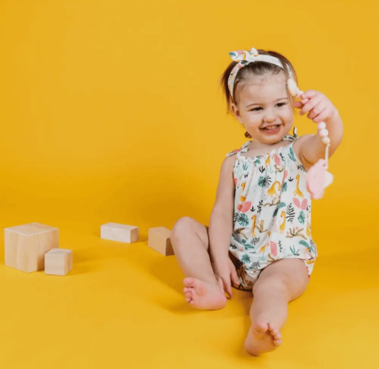 The Petite Giraffe Bubble romper with tie